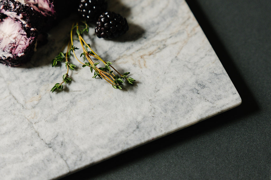 Aleutian marble charcuterie board styled with goat cheese for entertaining