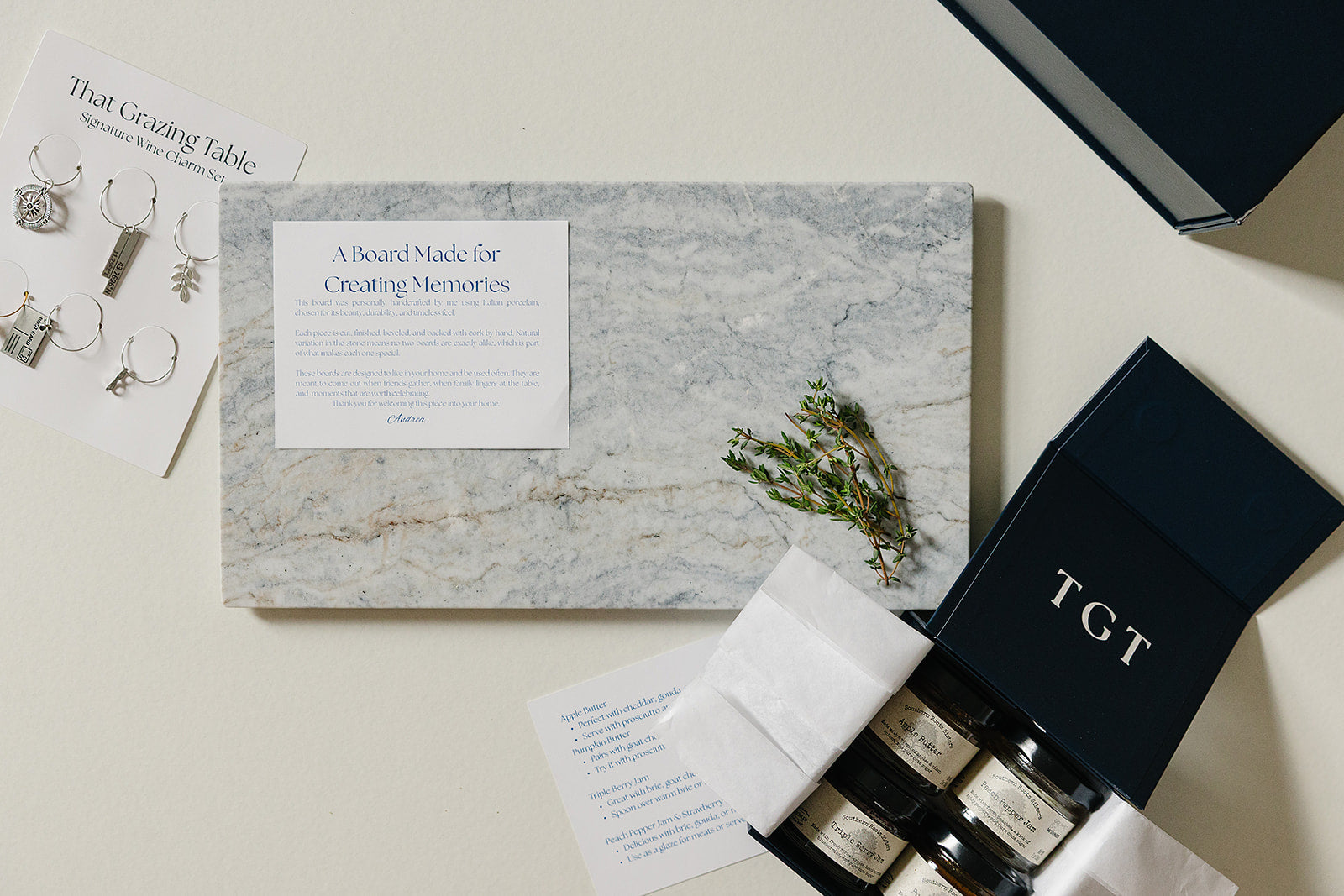 Aleutian Signature Set: handcrafted marble charcuterie gift set with artisan jams, wine charms, and navy keepsake box from That Grazing Table
