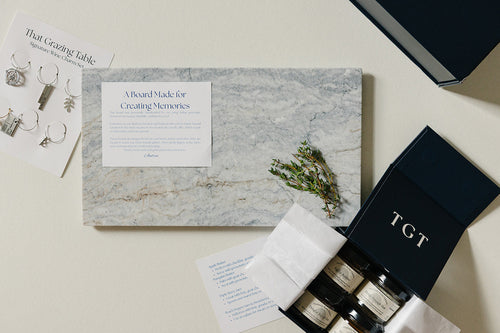 Aleutian Signature Set: handcrafted marble charcuterie gift set with artisan jams, wine charms, and navy keepsake box from That Grazing Table