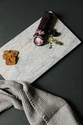 Handcrafted marble charcuterie board with goat cheese, crackers, and honey - Aleutian Collection