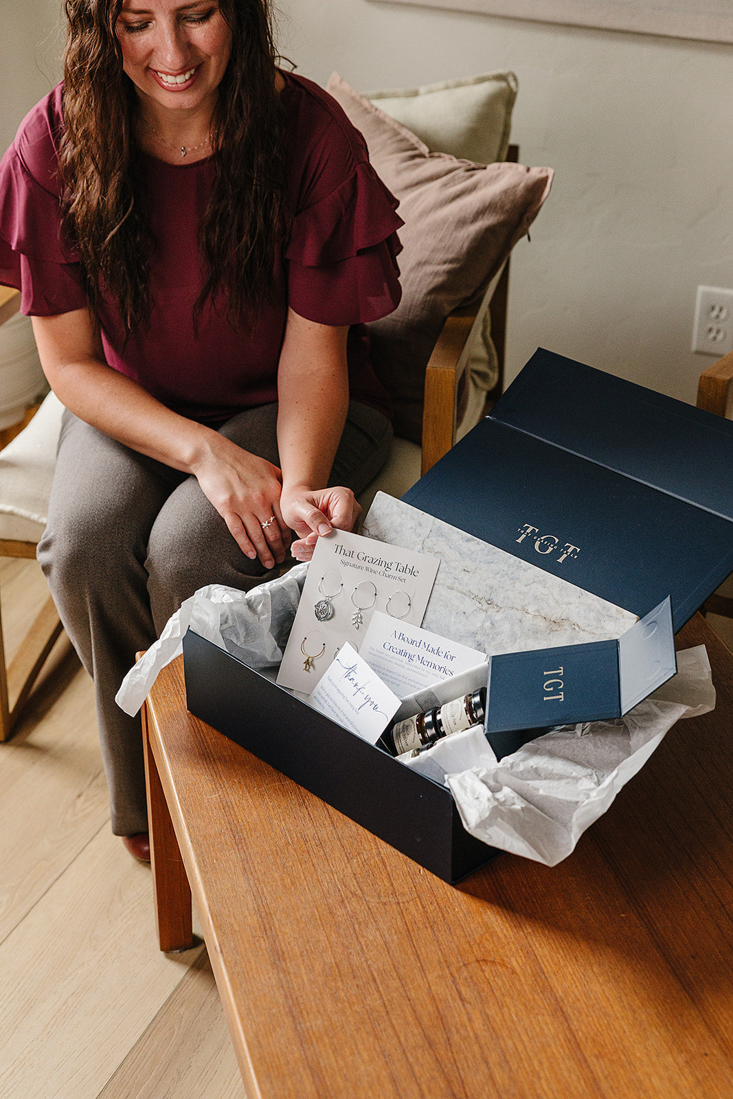 Smiling client unboxing the Aleutian Signature Set, a luxury client appreciation gift